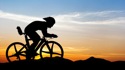 Fototapeta na wymiar Cycling at black mountain on twilight