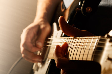 Man playing electric guitar - Powered by Adobe