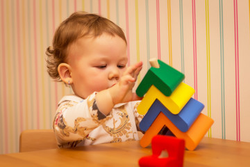 little girl playing with wooden toys, wooden tree