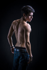 Fototapeta na wymiar Handsome muscular shirtless young man from the back