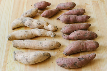 sweet potatoes on wooden background