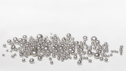 Pure silver granules on a white background