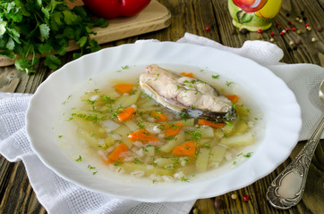 Homemade soup of fish and pearl barley