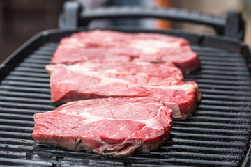Fresh beef steaks on grill or BBQ