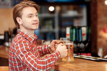 Young man with beer mugs