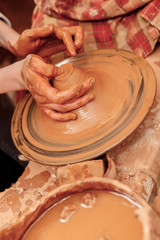 Shaping cay on pottery wheel