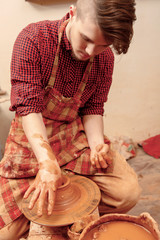 Man making a clay jar