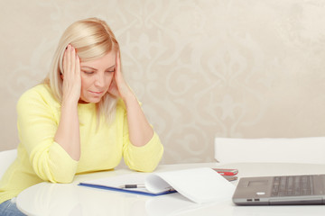 Woman works with papers at home