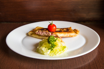 pancakes with ham and cheese on wooden background