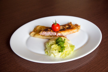 Crepes with ham and cheese decorated on wooden background