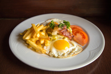 american breakfast with fried potato bacon eggs