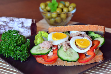 Rye bread sandwich with tuna fish, tomato and cucumber slices