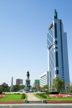 Modern skyscraper and statue in the center of Santiago de Chile