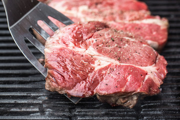 Beef steaks on grill or BBQ with spatula