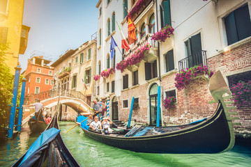 Fototapeta na wymiar Gondolas on canal in Venice, Italy with retro vintage filter