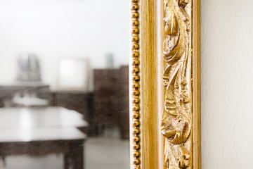 Detail of a carved and golden wooden frame - obrazy, fototapety, plakaty