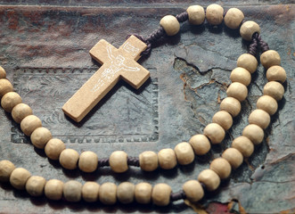 wooden rosary on the book