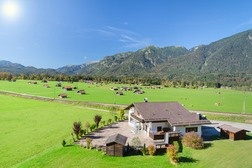 Alpine mountains summer green meadow in valley landscape