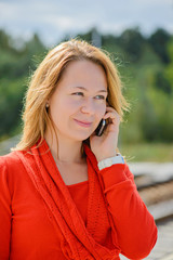 Young beautiful girl talking on mobile phone