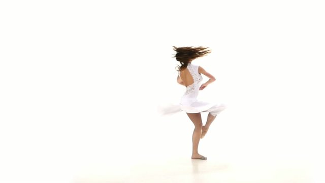 Young and slim woman in light dress dancing contemp jazz modern