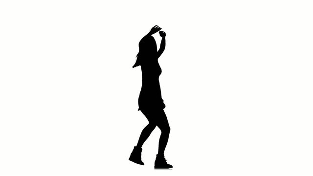 Slim young woman dancing on white background, slow motion