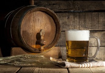 Beer barrel with beer mug on wooden background