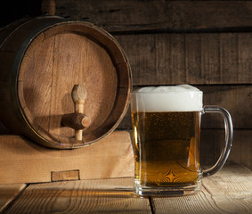 Beer barrel with beer mug on wooden background