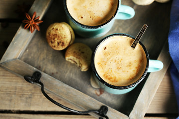 Beautiful composition with tasty cappuccino on wooden table