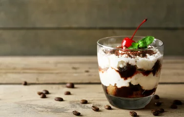 Möbelaufkleber Tasty tiramisu dessert in glass, on wooden background © Africa Studio