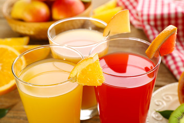Fototapeta premium Fresh juices with fruits on wooden table