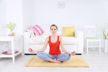 Young woman doing yoga at home