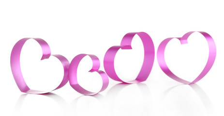 Purple hearts from ribbon isolated on white