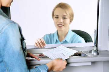Teller window with working cashier. Concept of payment of utilities