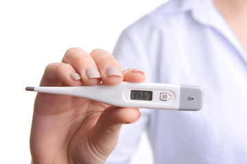 Doctor holding thermometer close up