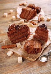 Slices of tasty chocolate cake on plate on table close up