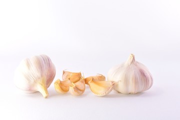 Mature garlic and cloves on a white background