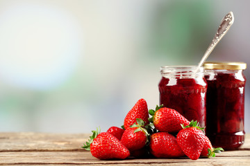 Jars of strawberry jam with berries