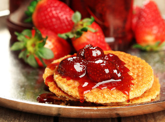 Wafers with strawberry jam and berries on tray close up