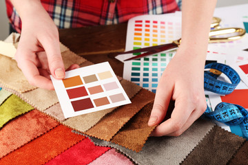 Woman working with scraps of colored tissue and palette close