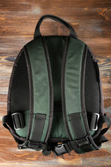Naklejka premium Backpack on wooden background