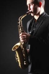 Fototapeta na wymiar Saxophone player Saxophonist with sax alto