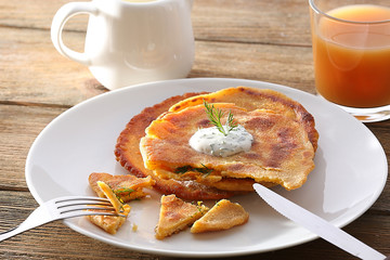 Stack of corn tortillas with stuffing and glass of juice