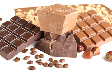 Chocolate bars with hazelnuts and coffee beans close up