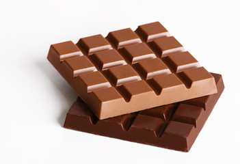 Milk and black chocolate bars isolated on white