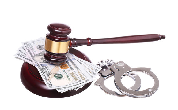 judge gavel and handcuffs with money isolated on white backgrou