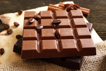 Delicious chocolates with spices on table, closeup