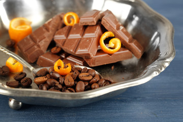 Chocolate with orange peels and coffee beans in metal tray