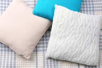 Decorative pillows on plaid close up