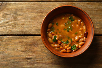 Bean soup in bowl on wooden table background