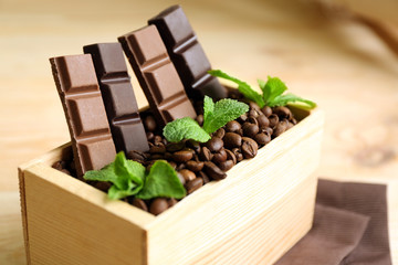 Still life with set of chocolate in wooden box of coffee grains